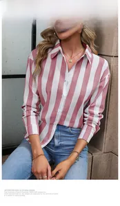 Detail of red and white striped women's button-down shirt with classic collar and cuffs