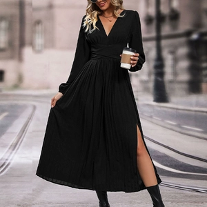 Detail of elegant black V-neck pleated dress with long sleeves and high slit waist design