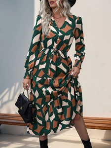 Detail of V-neck midi dress featuring geometric abstract print and drawstring waist