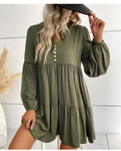 Detailed view of dark green dress with lantern sleeves and delicate lace patchwork
