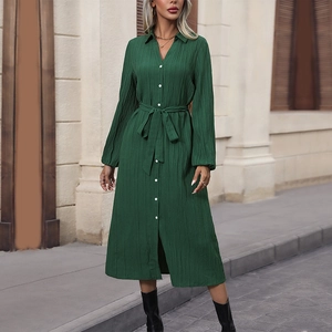 Elegant dark green pleated shirt dress with long sleeves and a matching tie belt in street style