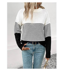 Close-up detail of the striped knitted texture and color-block stitching on the sweater