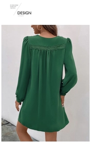 Detail of dark green V-neck dress featuring lace stitching and pleated back design