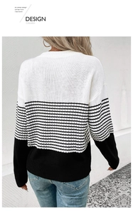 Detail of a knit long-sleeve sweater featuring a black and white striped pattern and crew neck