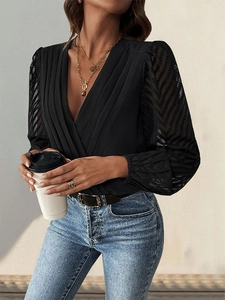 Detail of black V-neck wrap bodysuit with pleated chest and sheer lace chevron sleeves