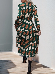 Detailed back view of a V-neck long-sleeve dress with geometric prints and layered hem