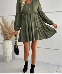 Detail of army green V-neck dress featuring lantern sleeves and white decorative buttons
