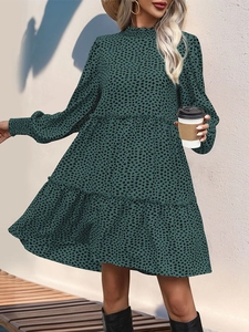 Detail of high neck ruffle and floral leopard print on dark green long sleeve dress