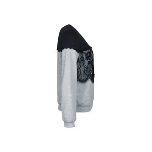 Detail of elegant black eyelash lace trim on long sleeve color-block sweatshirt