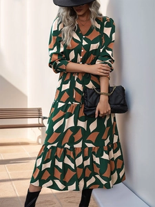 Detail of geometric print maxi dress with V-neck, buttons, and layered ruffle skirt design