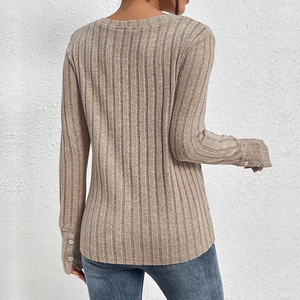 Slim fit beige ribbed knit long sleeve top with decorative buttons on cuffs shown from back