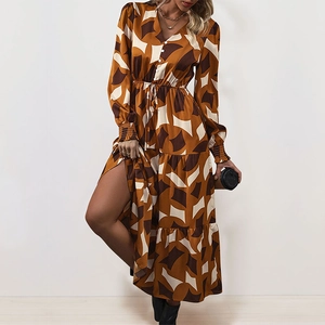 Detail view of V-neck maxi dress with geometric pattern, button front, and tiered hem design