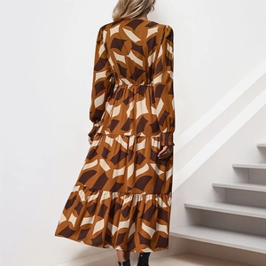 Detail of tiered geometric print maxi dress with long sleeves and caramel tones