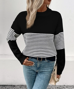 Detail of round neck striped sweater with ribbed cuffs and black and white contrast knit