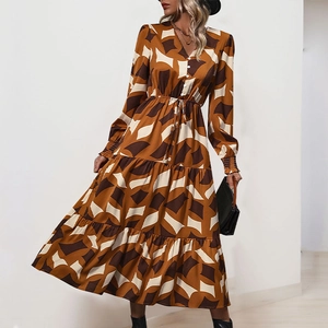 Close-up of bohemian V-neck maxi dress with geometric patterns and waist drawstring detail