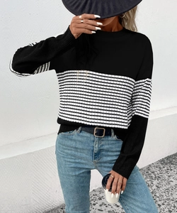 Detailed knit texture of a black and white striped long sleeve slim fit sweater top