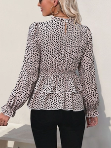 Detail of ruffle trim collar and back keyhole closure on leopard print blouse