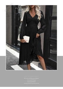 Close-up of black V-neck pleated midi dress with fine wave texture and long sleeves