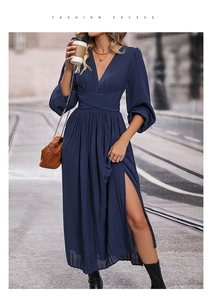 Detail of navy blue V-neck midi dress with lantern sleeves and a high side slit