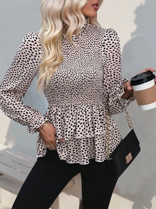 Detail of smocked high neck and peplum hem on women's floral print long sleeve blouse