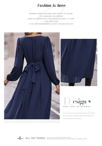 Detail view of navy blue pleated dress featuring elastic cuffs and a waist tie ribbon