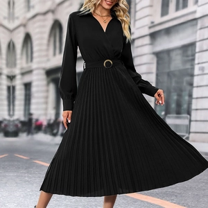 Detail of elegant black pleated maxi dress featuring a lapel V-neck and belted waistline
