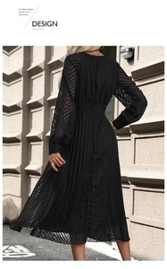 Detail view of black pleated dress featuring elegant lace sleeves and back zipper closure