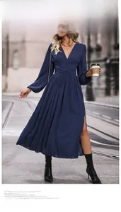 Detail of navy blue pleated midi dress featuring a deep V-neck and high side slit