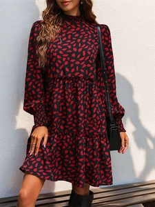 Detail of smocked cuffs and tiered floral print skirt on this long sleeve dress