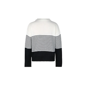 Detail view showing the tri-color block knit sweater with black and white striped pattern
