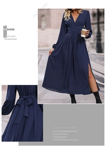 Detail of elegant navy blue pleated dress featuring a high side slit and V-neckline