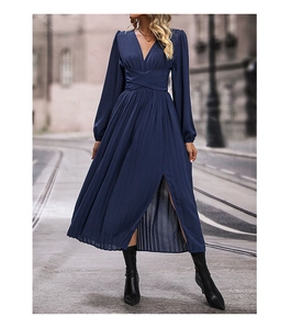 Detail of elegant dark blue long sleeve dress featuring V-neck and pleated skirt