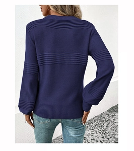 Rear view of navy blue long sleeve knit sweater featuring horizontal textured patterns