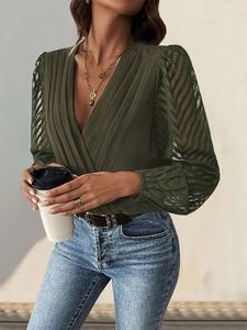 Close-up of olive green V-neck bodysuit showing pleated front and sheer lace sleeves