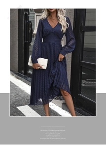 Detail view of navy blue pleated long-sleeve V-neck dress with wave texture fabric