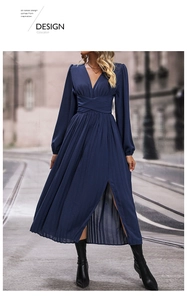 Detail of navy long-sleeve pleated dress featuring a deep V-neck and stylish side slit