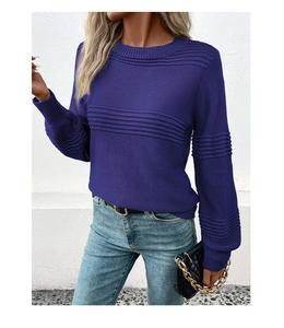 Detail of deep purple long sleeve knit sweater showing textured ribbed pattern stitching