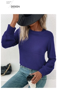 Detail of blue long sleeve sweater featuring horizontal ribbed texture on chest and shoulder