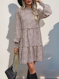 Detailed view of leopard print long sleeve dress with smocked cuffs and tiered skirt