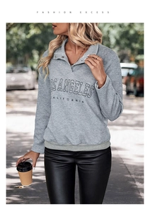 Detail of grey polo collar sweatshirt with LOS ANGELES print and quilted texture