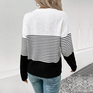 Relaxed color-block knit sweater with striped panel and black hem, back view display