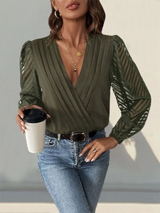 Detail of olive green wrap bodysuit featuring V-neck pleats and sheer lace sleeves