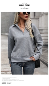 Detail showing grey textured long sleeve pullover with geometric patterns and V-neck collar