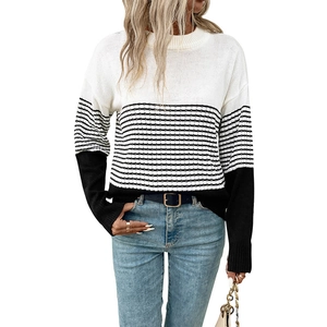 Women's knit crewneck sweater featuring a bold black and white striped colorblock design