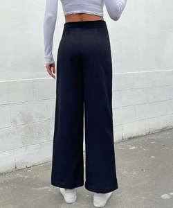 Rear view of high-waist black wide-leg trousers with sleek drape and slimming fit