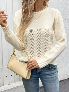 Detail of hollow-out wave knit texture on long sleeve cream sweater with golden jewelry