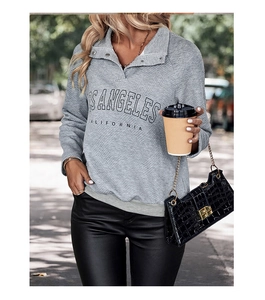 Detail of grey diamond textured sweatshirt with snap button collar and Los Angeles print