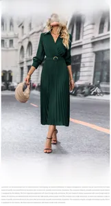 Detail of dark green pleated maxi dress featuring a V-neck wrap design and waist belt