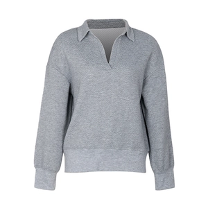 Detailed view of the diamond-textured fabric on this grey V-neck pullover sweatshirt