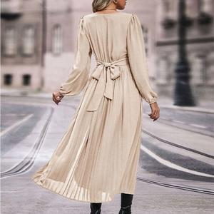 Elegant beige long sleeve maxi dress with pleated skirt and waist tie detail